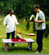 Two guys discussing a slice of watermelon